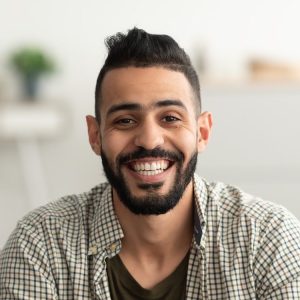 Stock portrait of a smiling man seated indoors